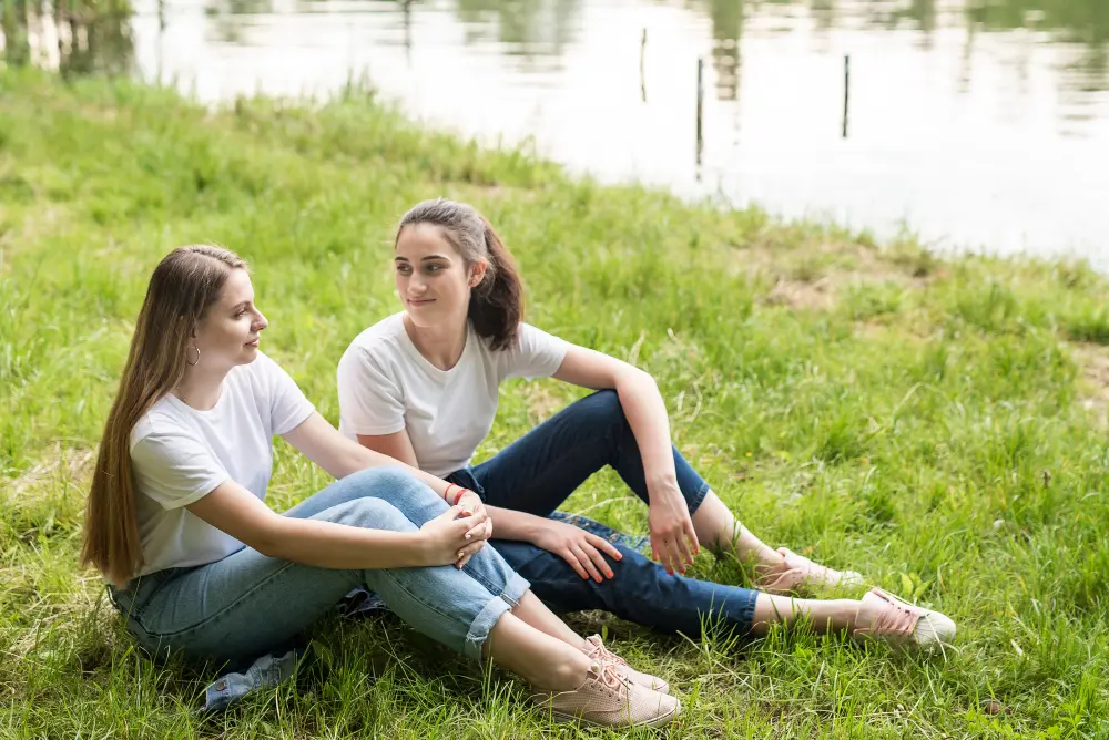Women enjoying a lighthearted moment together outdoors, illustrating the joy and emotional resilience found through professional counseling for women in Orlando.