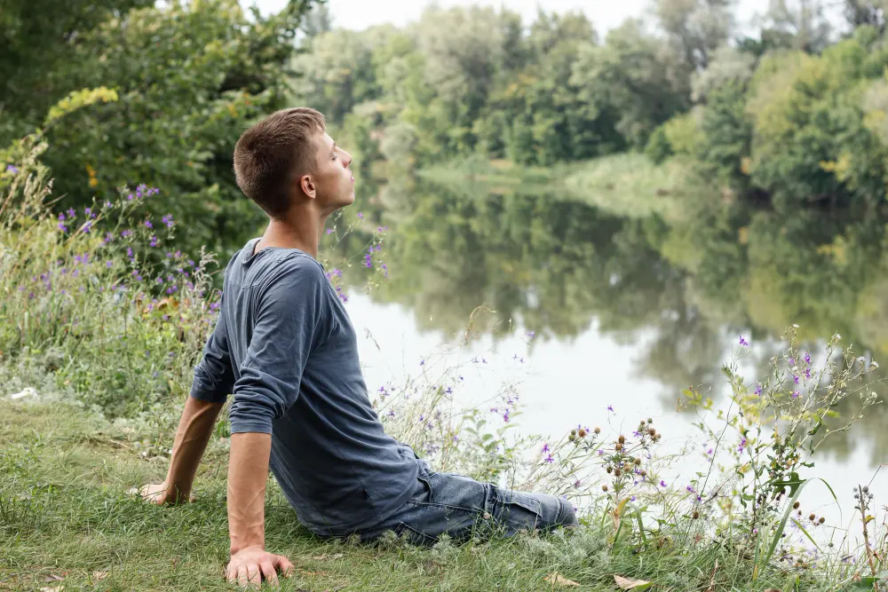 A man practicing mindfulness in nature to manage stress and anxiety, reflecting the holistic approach of Orlando Thrive Therapy.